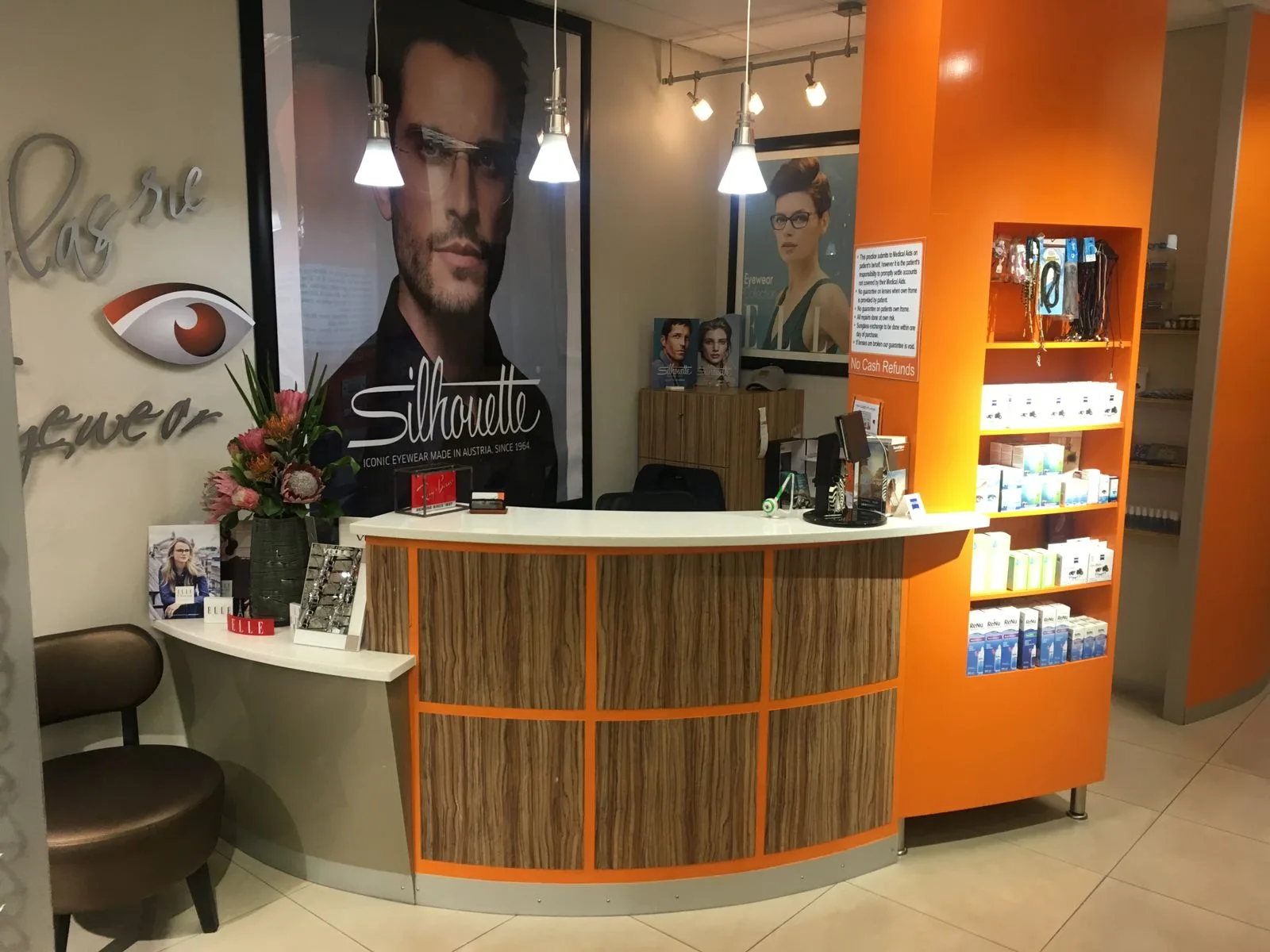 Orange custom shop counter with storage and display space.