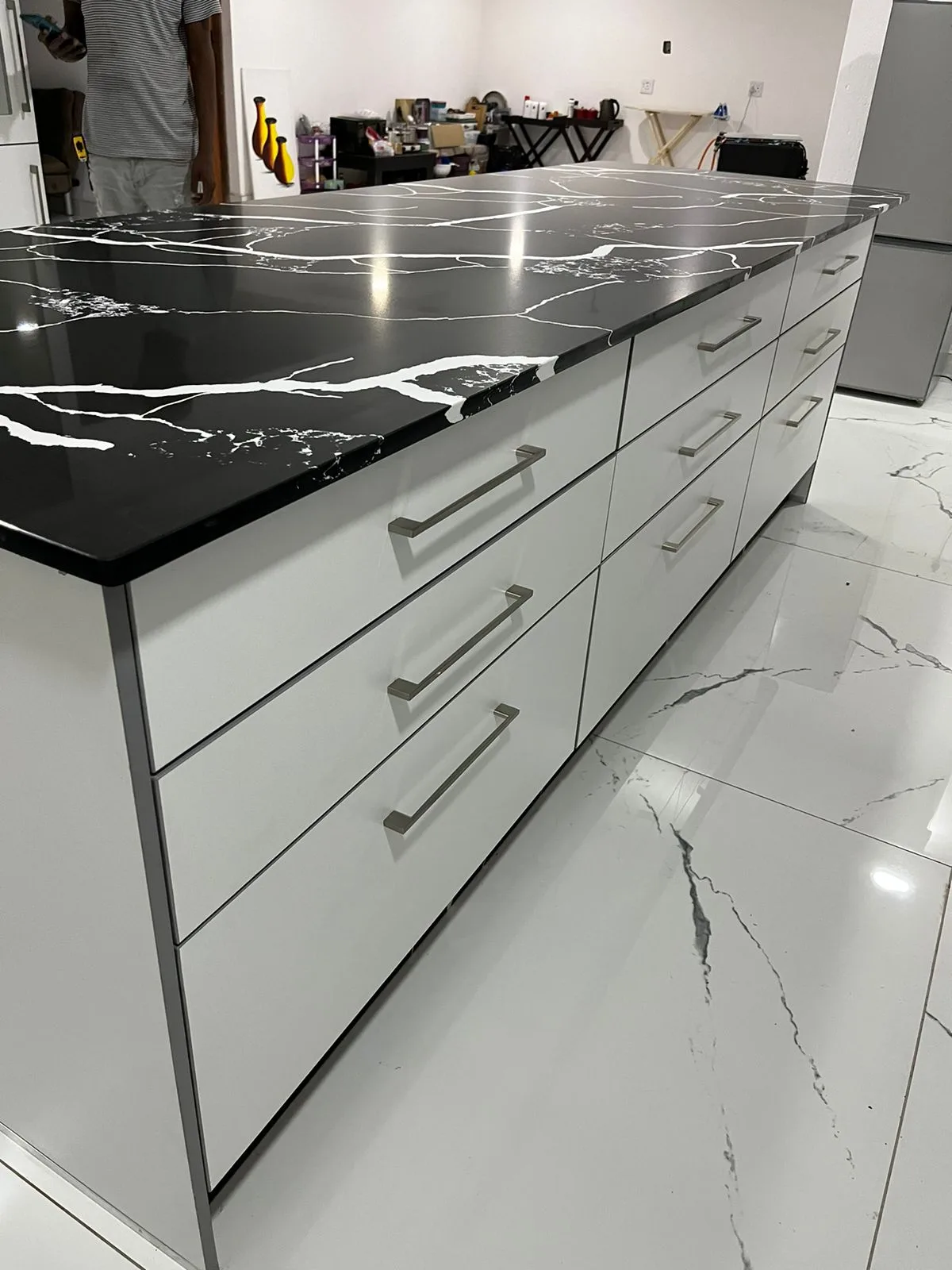 Black and white quartz countertop with white built-in cabinets, featuring a sleek and modern design.